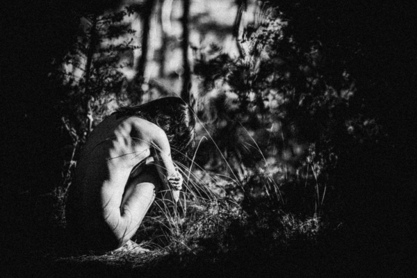 Only You Are Close, When Everything Is Far Away, a figure crouching among dark foliage